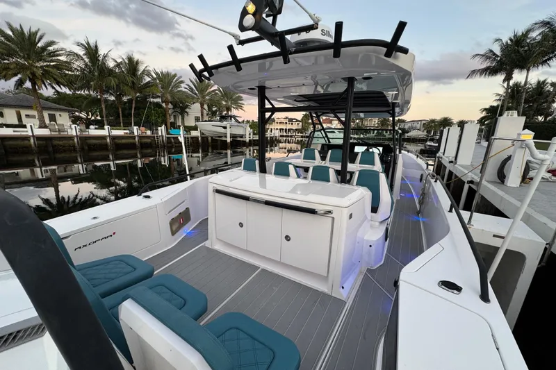  Yacht Photos Pics 2021 Axopar 37 Sun Top boat docked, featuring sleek design and modern seating.