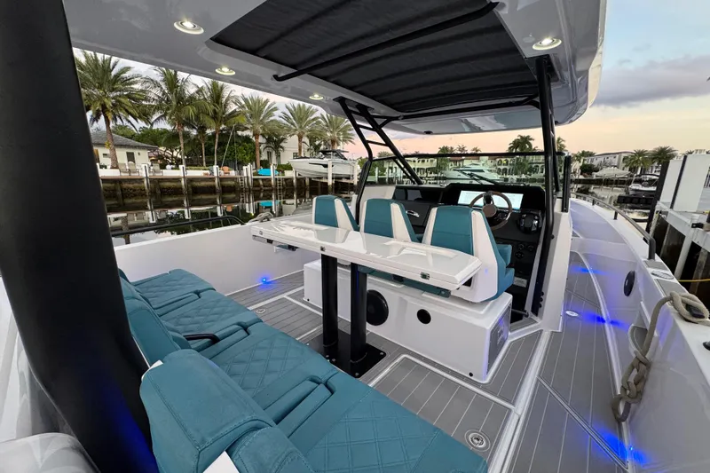  Yacht Photos Pics 2021 Axopar 37 Sun Top boat interior with seating, table, and modern design.
