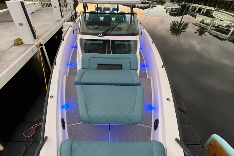  Yacht Photos Pics 2021 Axopar 37 Sun Top boat with blue LED lights and teal seating.