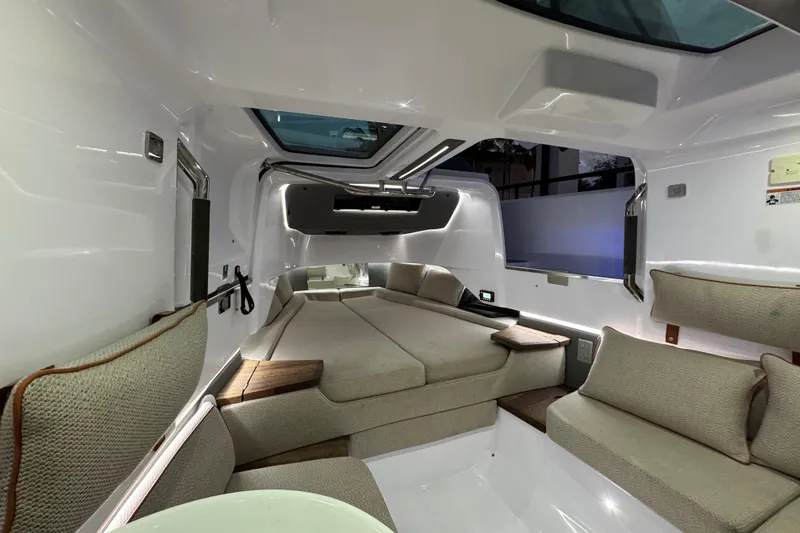  Yacht Photos Pics Luxurious interior of 2021 Axopar 37 Sun Top boat with modern seating and skylight.