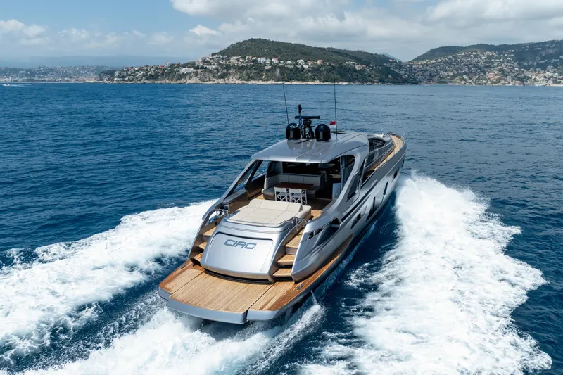 Ciao Yacht Photos Pics 2024 Pershing 7X yacht cruising on open sea with scenic coastal backdrop.