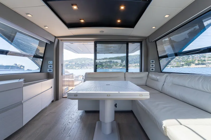 Ciao Yacht Photos Pics Luxurious interior of 2024 Pershing 7X yacht with panoramic windows and elegant seating.