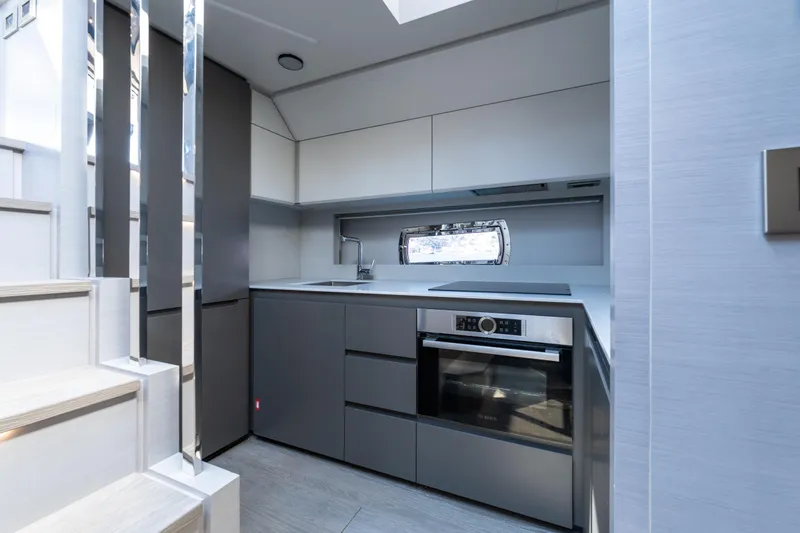 Ciao Yacht Photos Pics Modern kitchen interior on 2024 Pershing 7X yacht, featuring sleek cabinetry and built-in appliances.