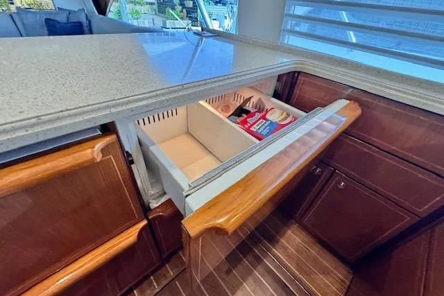 Pipe Dream Yacht Photos Pics 2005 Ocean Yachts 50 Super Sport kitchen with open drawer, showcasing storage space.