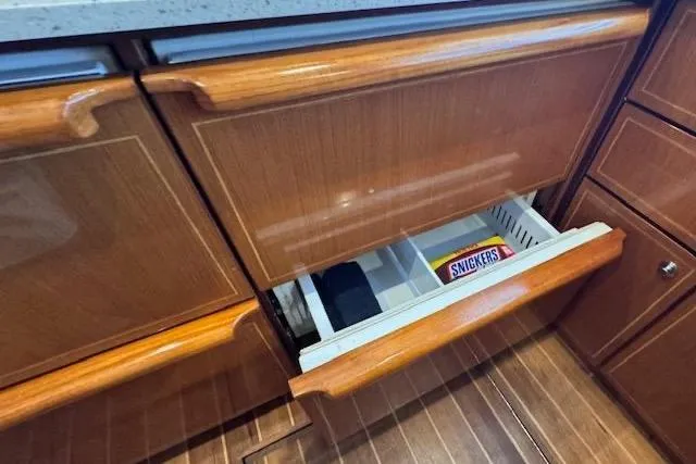 Pipe Dream Yacht Photos Pics Wooden drawer in 2005 Ocean Yachts 50 Super Sport, containing a Snickers bar.