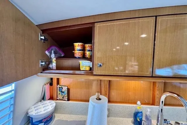 Pipe Dream Yacht Photos Pics Kitchen area in 2005 Ocean Yachts 50 Super Sport with wooden cabinets and countertop essentials.