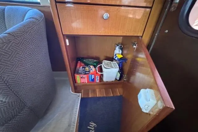 Pipe Dream Yacht Photos Pics Cabinet interior on 2005 Ocean Yachts 50 Super Sport, showing storage with various items.