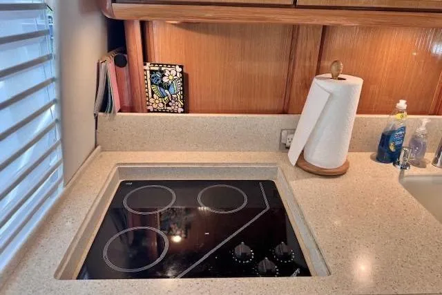 Pipe Dream Yacht Photos Pics Modern kitchen area in a 2005 Ocean Yachts 50 Super Sport with electric stovetop.