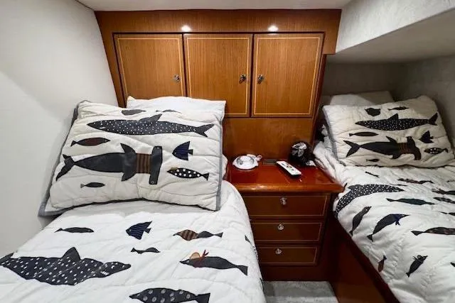 Pipe Dream Yacht Photos Pics Twin beds with fish-themed bedding in 2005 Ocean Yachts 50 Super Sport cabin.