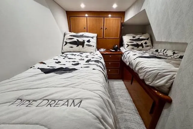 Pipe Dream Yacht Photos Pics 2005 Ocean Yachts 50 Super Sport cabin with twin beds and nautical-themed bedding.