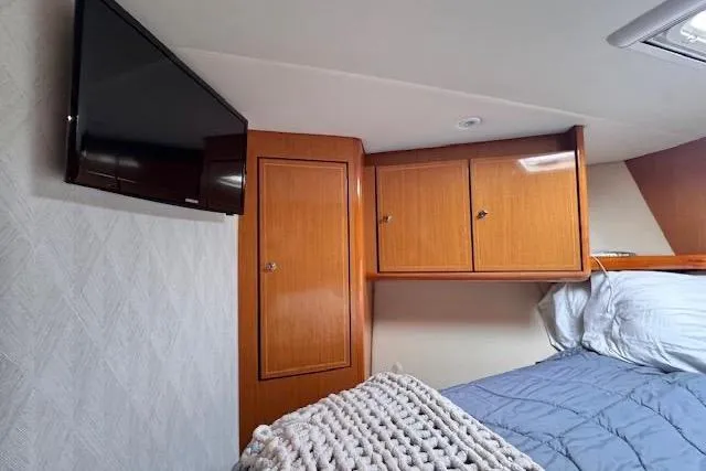 Pipe Dream Yacht Photos Pics Interior cabin of 2005 Ocean Yachts 50 Super Sport with TV and wooden cabinets.