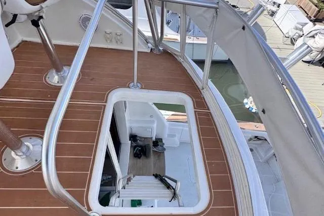 Pipe Dream Yacht Photos Pics 2005 Ocean Yachts 50 Super Sport boat deck with open hatch and railing.