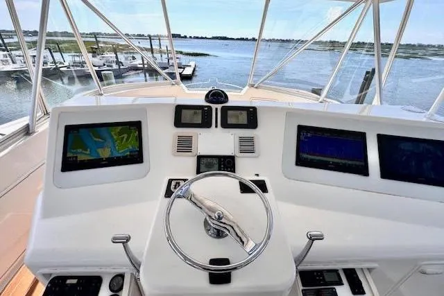Pipe Dream Yacht Photos Pics Helm of 2005 Ocean Yachts 50 Super Sport with navigation screens and steering wheel.