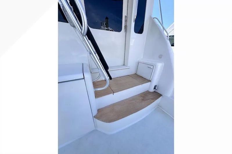 Pipe Dream Yacht Photos Pics Staircase on 2005 Ocean Yachts 50 Super Sport, featuring sleek design and wooden steps.