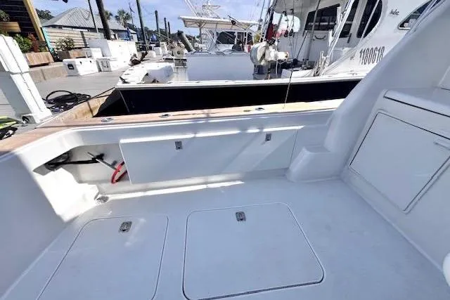 Pipe Dream Yacht Photos Pics 2005 Ocean Yachts 50 Super Sport boat deck with storage compartments at a marina.