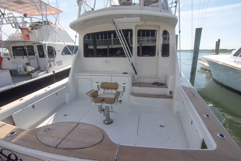 Pipe Dream Yacht Photos Pics 2005 Ocean Yachts 50 Super Sport fishing deck with chair, docked at marina.