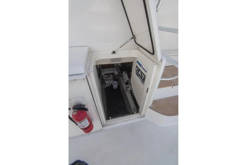 Pipe Dream Yacht Photos Pics Engine compartment of 2005 Ocean Yachts 50 Super Sport with visible fire extinguisher.