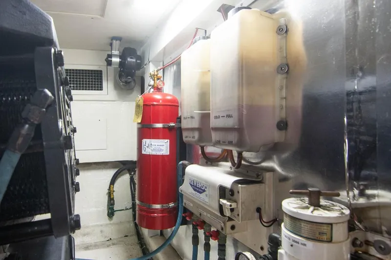 Pipe Dream Yacht Photos Pics Engine room of 2005 Ocean Yachts 50 Super Sport with fire extinguisher and equipment.