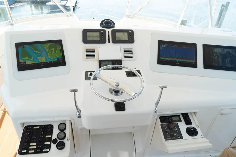 Pipe Dream Yacht Photos Pics Control panel of 2005 Ocean Yachts 50 Super Sport with navigation screens and steering wheel.