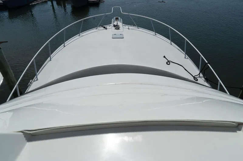 Pipe Dream Yacht Photos Pics 2005 Ocean Yachts 50 Super Sport yacht bow view on calm water.
