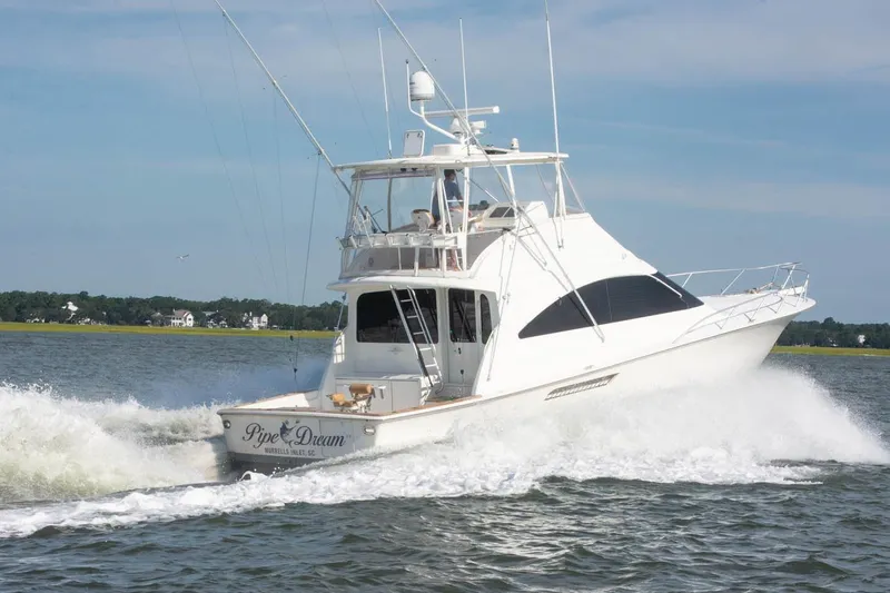 Pipe Dream Yacht Photos Pics 2005 Ocean Yachts 50 Super Sport cruising on open water, creating a wake.