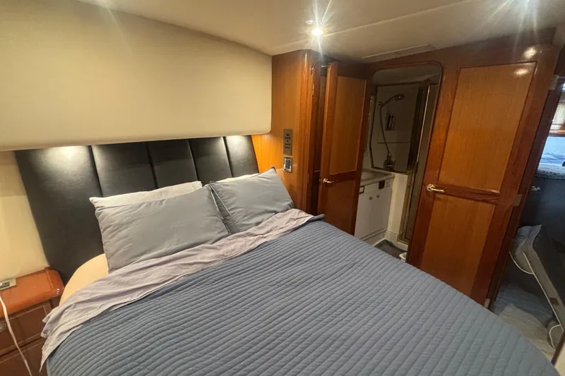 Pipe Dream Yacht Photos Pics Luxurious bedroom interior of 2005 Ocean Yachts 50 Super Sport with ensuite bathroom.