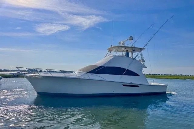 Pipe Dream Yacht Photos Pics 2005 Ocean Yachts 50 Super Sport cruising on calm waters under a clear blue sky.