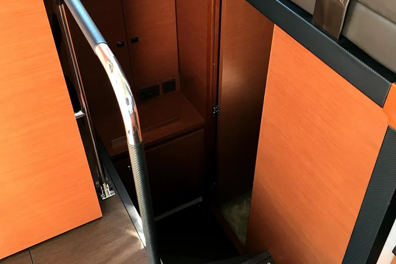  Yacht Photos Pics Interior staircase of 2017 Prestige 420S Coupé yacht with wooden finish and metal railing.