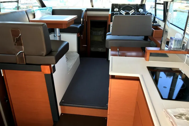  Yacht Photos Pics Interior of 2017 Prestige 420S Coupé yacht with modern seating and kitchen area.