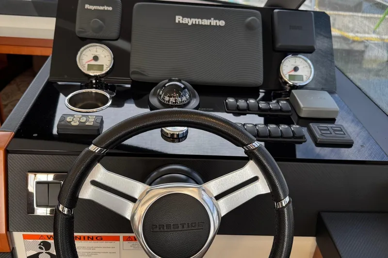  Yacht Photos Pics Steering wheel and dashboard of 2017 Prestige 420S Coupé yacht with navigation instruments.
