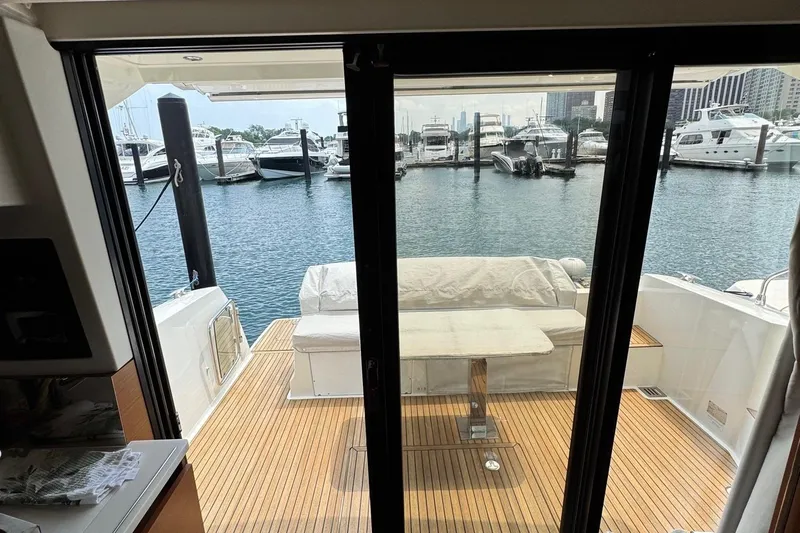  Yacht Photos Pics Prestige 420S Coupé 2017 yacht interior with marina view through glass doors.