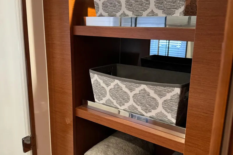  Yacht Photos Pics Wooden shelf with patterned storage boxes inside a Prestige 420S Coupé, 2017 model.