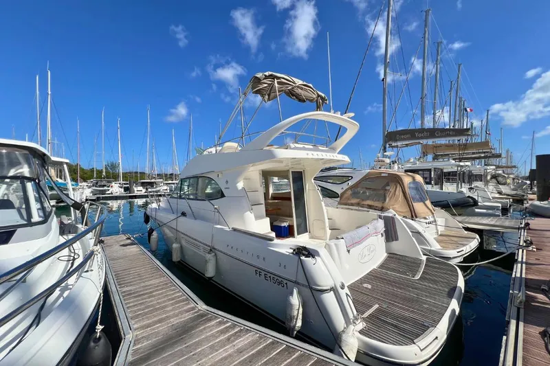  Yacht Photos Pics 2005 Jeanneau Prestige 36 yacht docked in a marina under a clear blue sky.