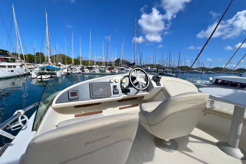  Yacht Photos Pics Helm of 2005 Jeanneau Prestige 36 yacht in marina, clear sky, sailboats in background.