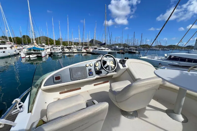  Yacht Photos Pics Flybridge of 2005 Jeanneau Prestige 36 yacht in marina, featuring helm and seating.