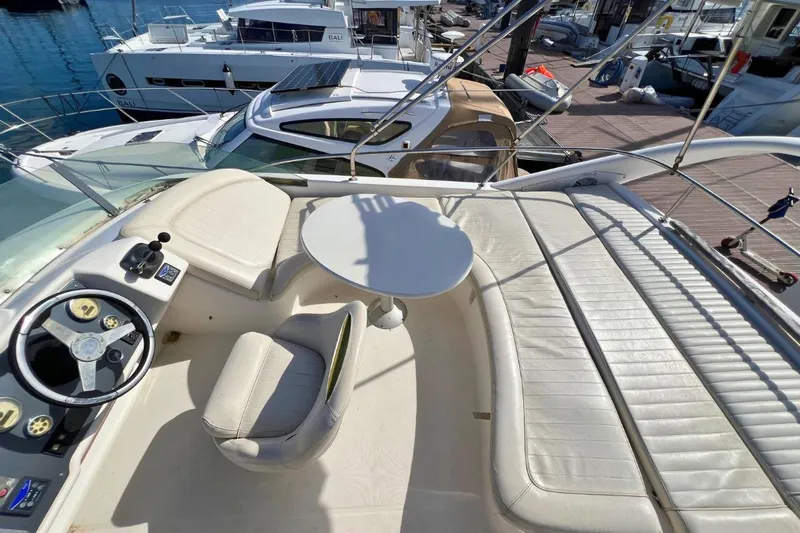  Yacht Photos Pics Flybridge of 2005 Jeanneau Prestige 36 yacht with seating and steering wheel.