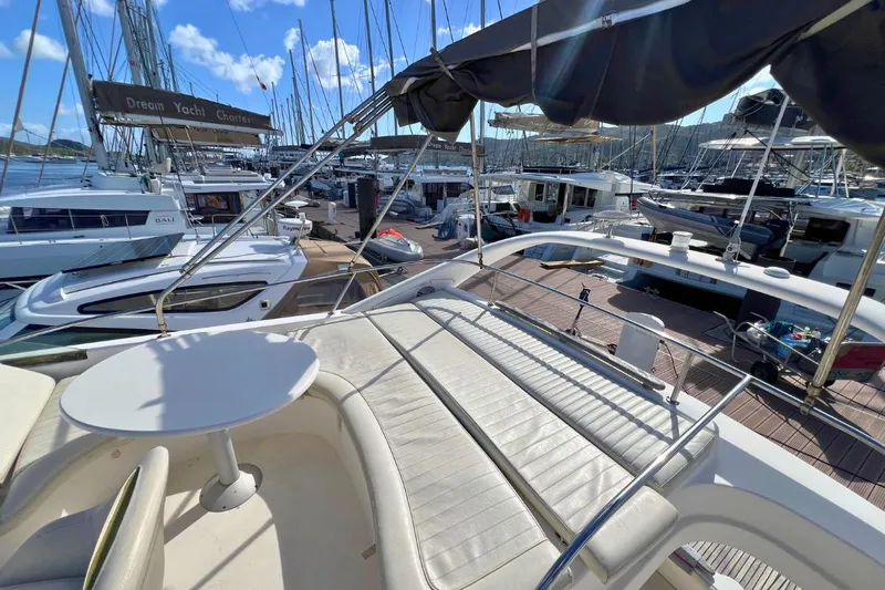  Yacht Photos Pics Flybridge view of 2005 Jeanneau Prestige 36 yacht in marina, surrounded by other boats.