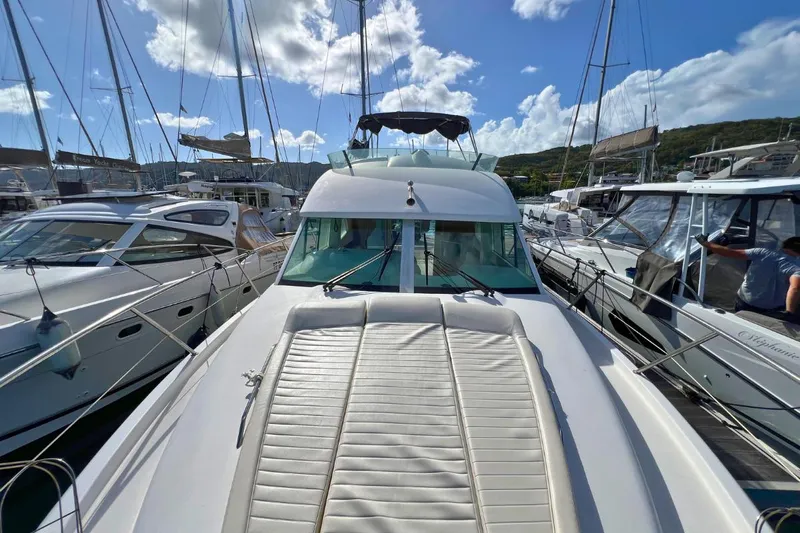  Yacht Photos Pics 2005 Jeanneau Prestige 36 yacht docked in a marina under a bright blue sky.