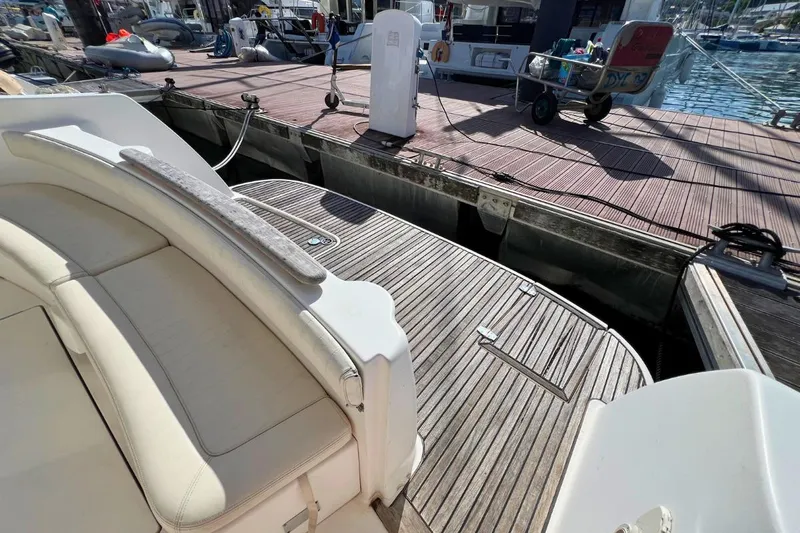  Yacht Photos Pics 2005 Jeanneau Prestige 36 yacht with wooden deck at marina dock.