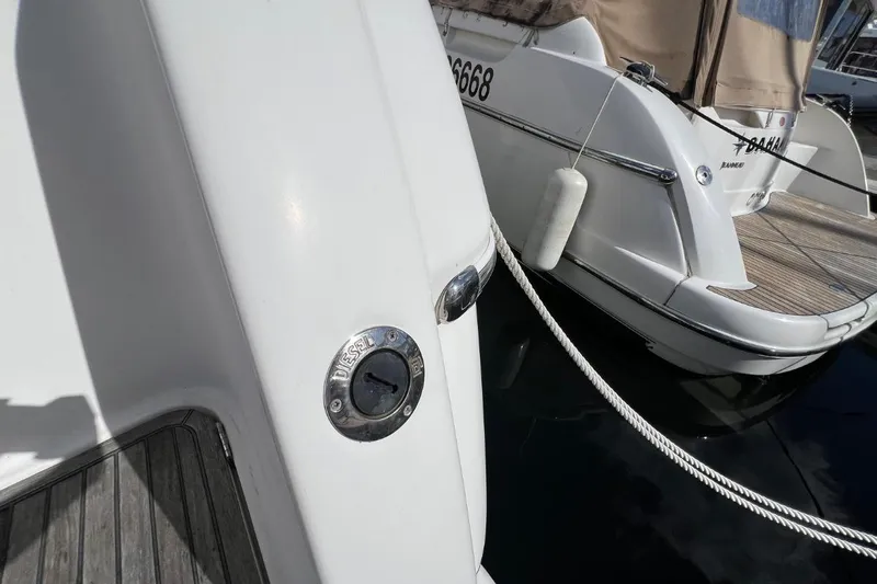  Yacht Photos Pics 2005 Jeanneau Prestige 36 yacht docked with visible mooring lines and fender.