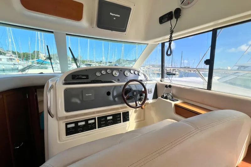  Yacht Photos Pics Helm of 2005 Jeanneau Prestige 36 yacht with steering wheel and control panel.