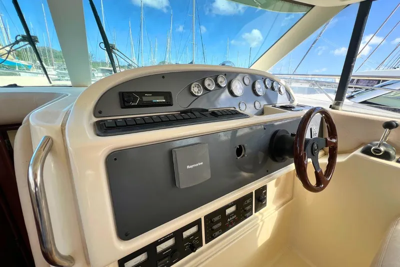  Yacht Photos Pics Helm of 2005 Jeanneau Prestige 36 yacht with steering wheel and control panel.