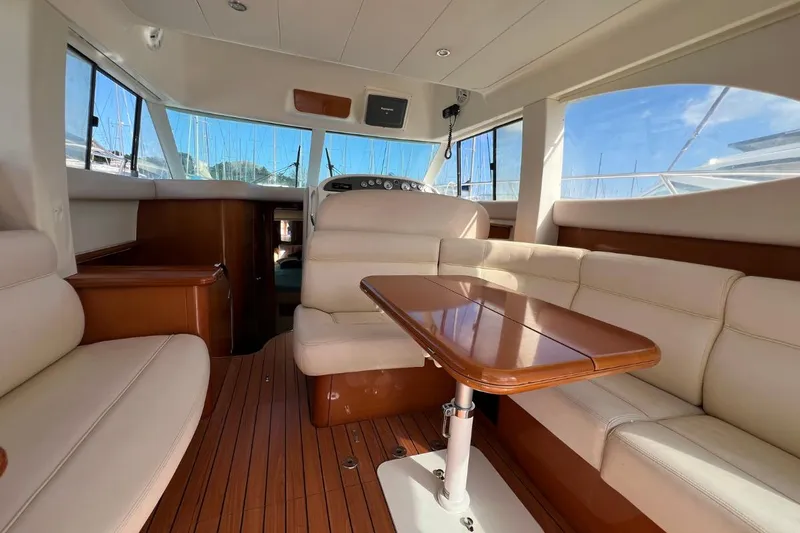  Yacht Photos Pics Luxurious interior of a 2005 Jeanneau Prestige 36 yacht with elegant seating and wooden table.