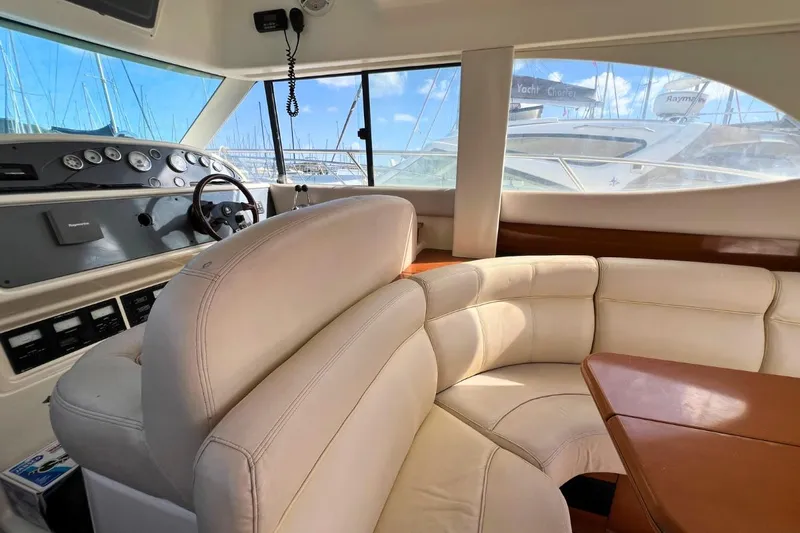  Yacht Photos Pics Interior of 2005 Jeanneau Prestige 36 yacht with plush seating and helm.