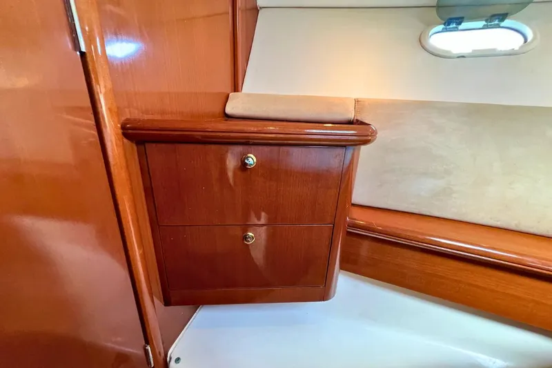  Yacht Photos Pics 2005 Jeanneau Prestige 36 interior with wooden cabinetry and porthole.
