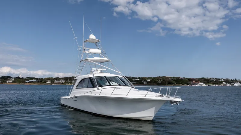 Life Of Reilly 2.0 Yacht Photos Pics 2012 Cabo 44 HTX yacht on calm water under a partly cloudy sky.