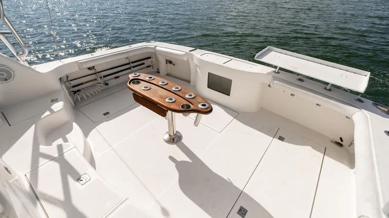 Life Of Reilly 2.0 Yacht Photos Pics 2012 Cabo 44 HTX boat deck with fishing rod holders, on calm water.