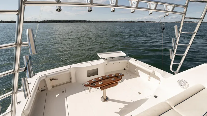 Life Of Reilly 2.0 Yacht Photos Pics Cabo 44 HTX 2012 yacht deck with fishing rod holders, overlooking calm waters.