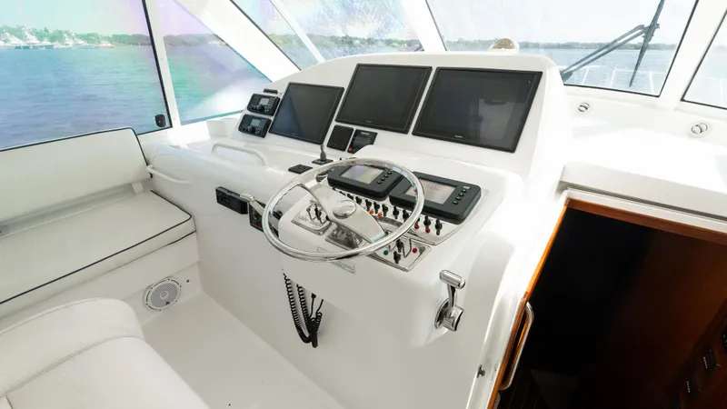 Life Of Reilly 2.0 Yacht Photos Pics Helm of 2012 Cabo 44 HTX yacht with modern navigation equipment and steering wheel.