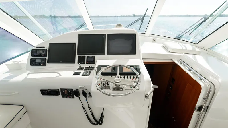 Life Of Reilly 2.0 Yacht Photos Pics Helm of 2012 Cabo 44 HTX yacht with navigation equipment and steering wheel.